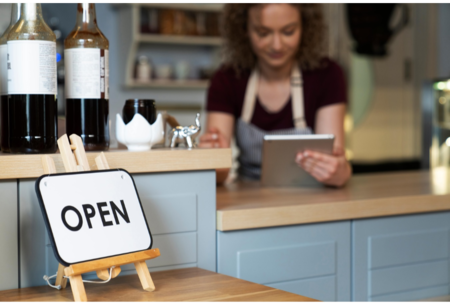 sign of being open in the foreground and waitress