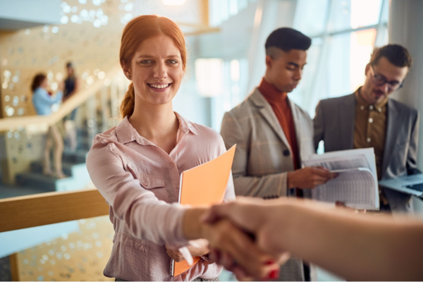 business woman is handshaking while standing