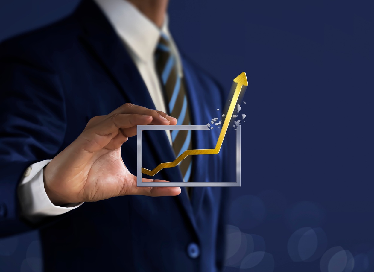 businessman is holding a growing graph