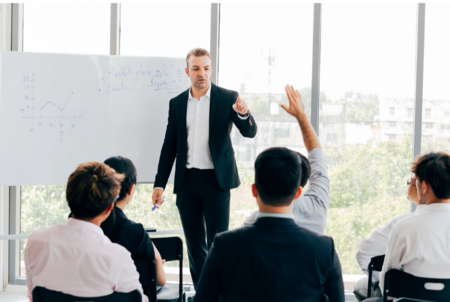 business coach answering question in meeting