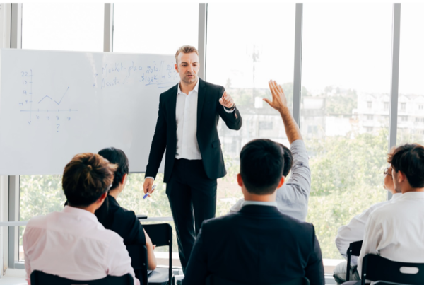 business coach answering question in meeting